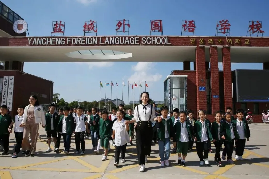 The main gate of Yancheng Foreign Language School, with students arriving for the day